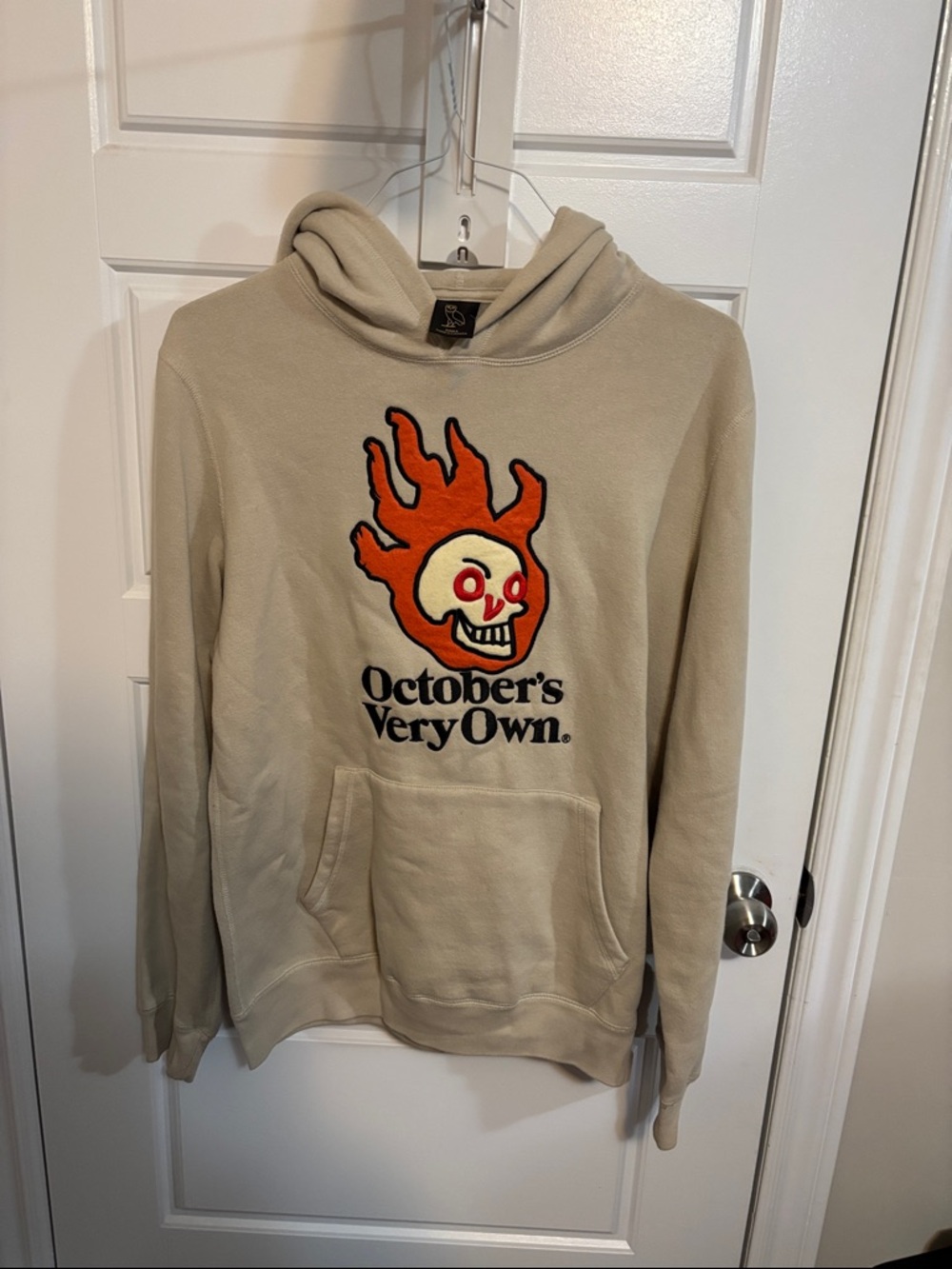 OVO Beige Hoodie with Orange Flame Skull Graphic
